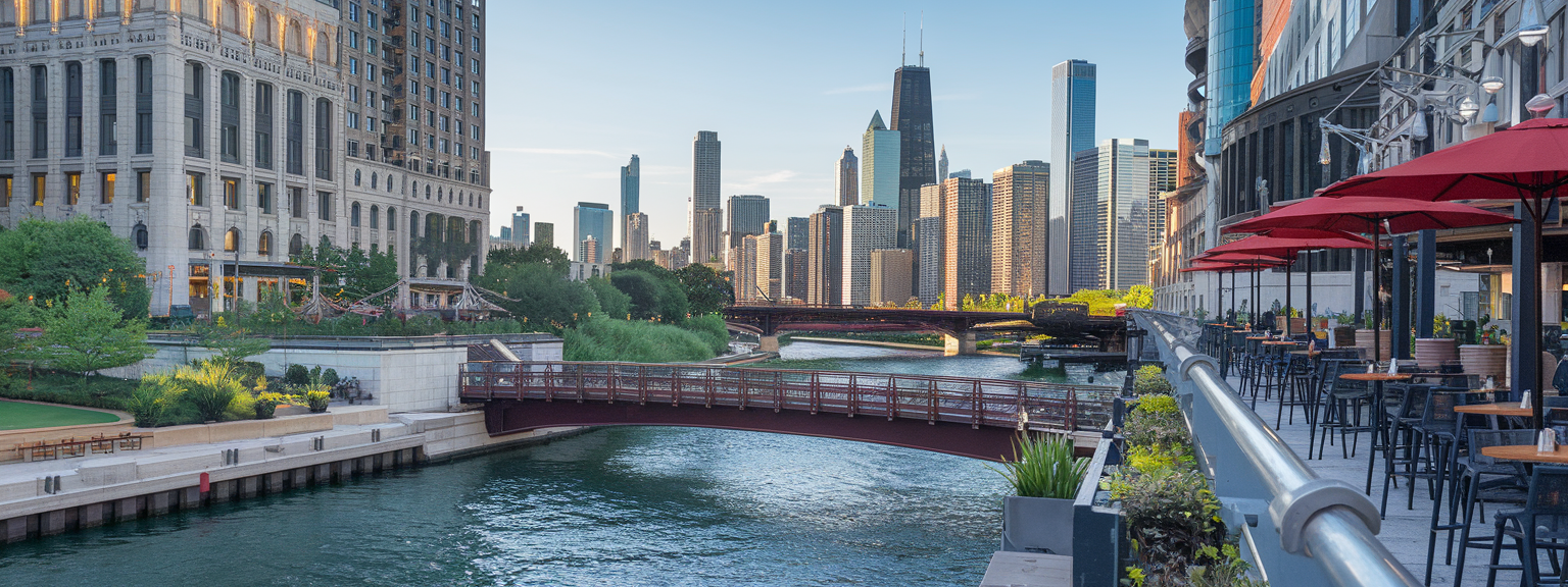 A scenic view showcasing the vibrant Chicago Riverwalk with restaurants and charming rooftops.
