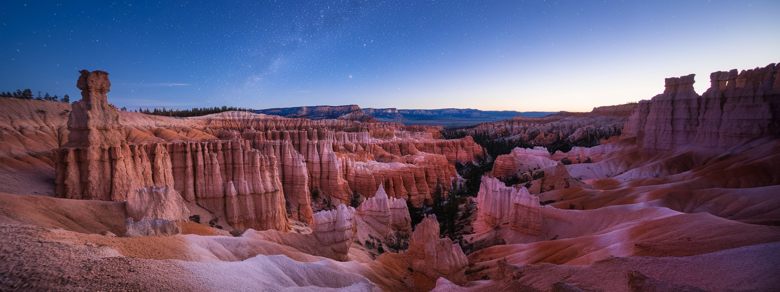 A stunning view of the starry sky over Bryce Canyon showcasing its unique rock formations.