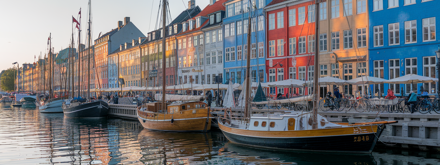 Vibrant Nyhavn waterfront with bikes and cafes from the Copenhagen Travel Guide.